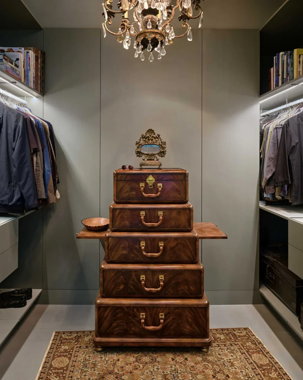 Walk-in closet with under-shelf lighting and a chandelier