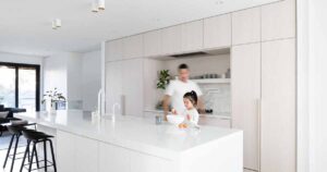 white-stained-oak-cabinets-paired-with-cool-white-marble-creates-a-soft-aesthetic-inside-this-home