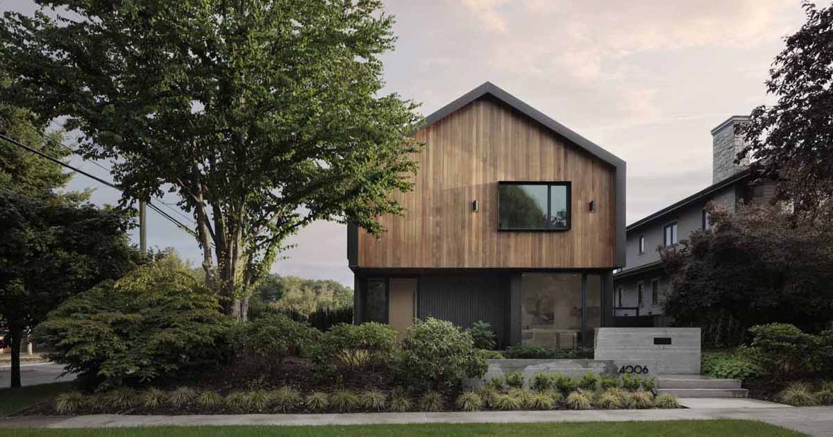 metal-cladding-wraps-around-the-large-gable-roof-of-this-house