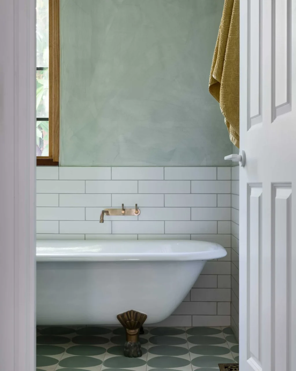 Restored clawfoot bathtub kept in the renovated bathroom