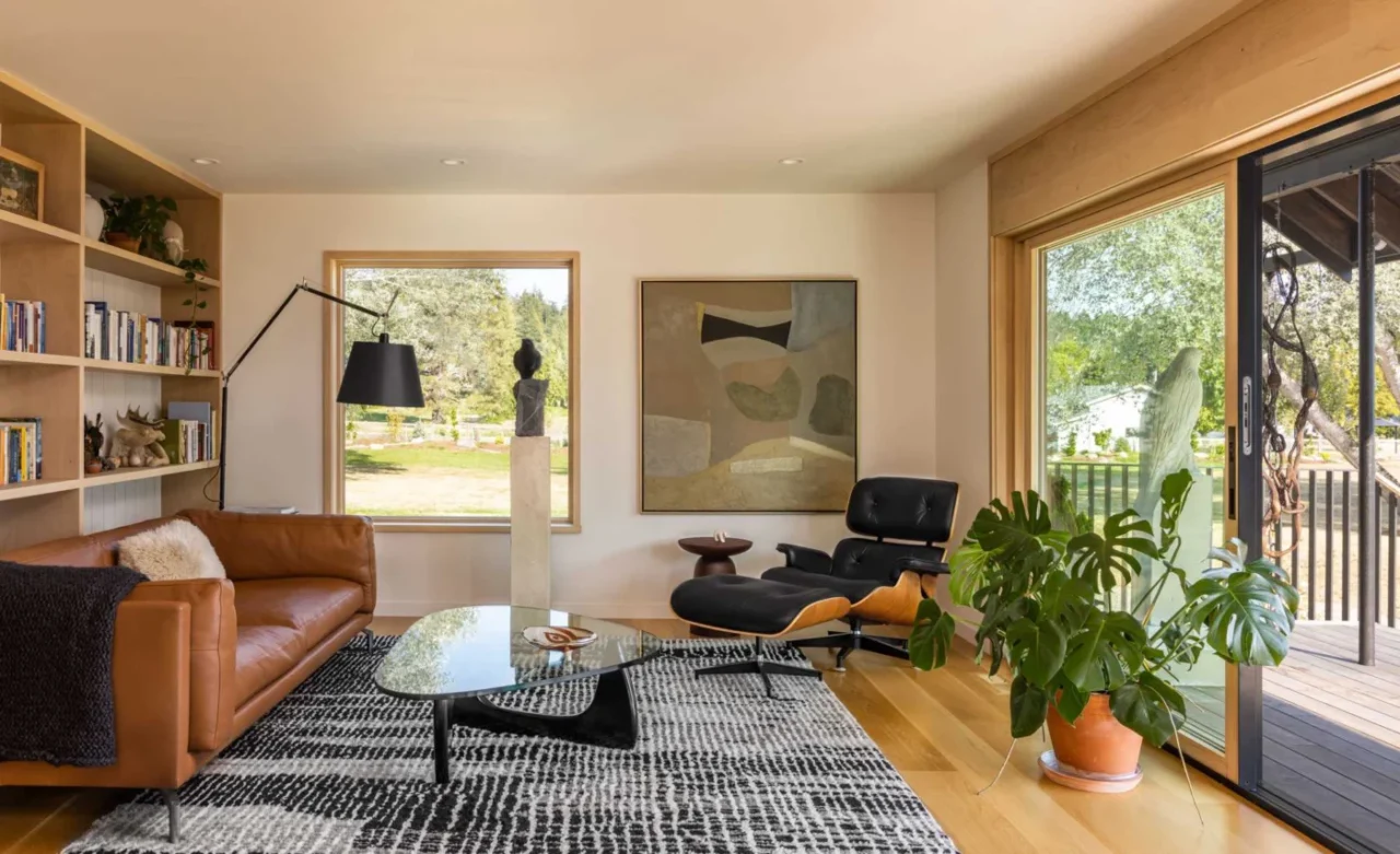 Open living room with picture windows and timber shelving