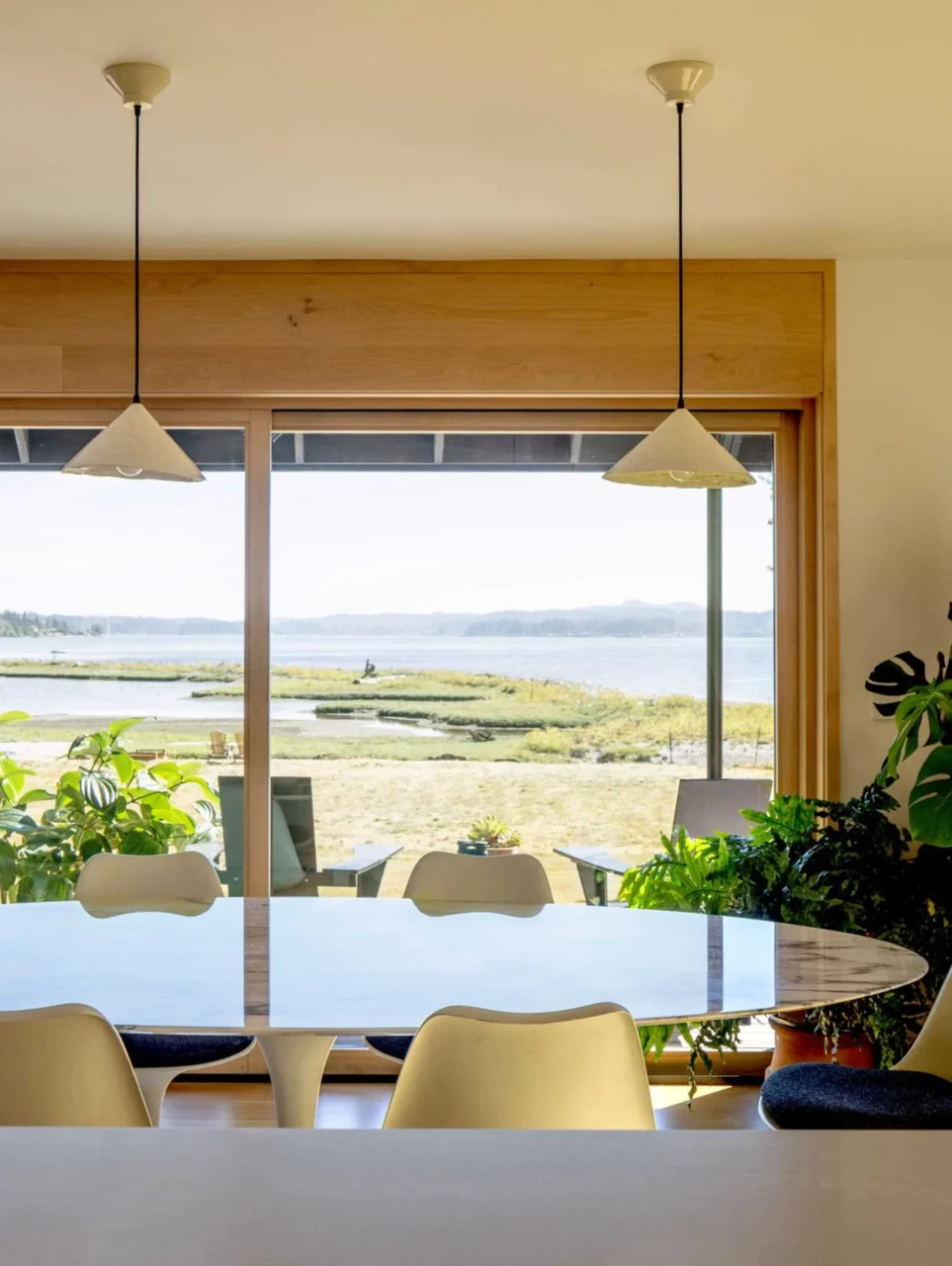 Open-plan dining area with views of the porch and water