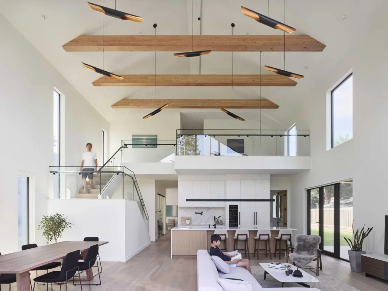 Open living, dining and kitchen area under a vaulted ceiling