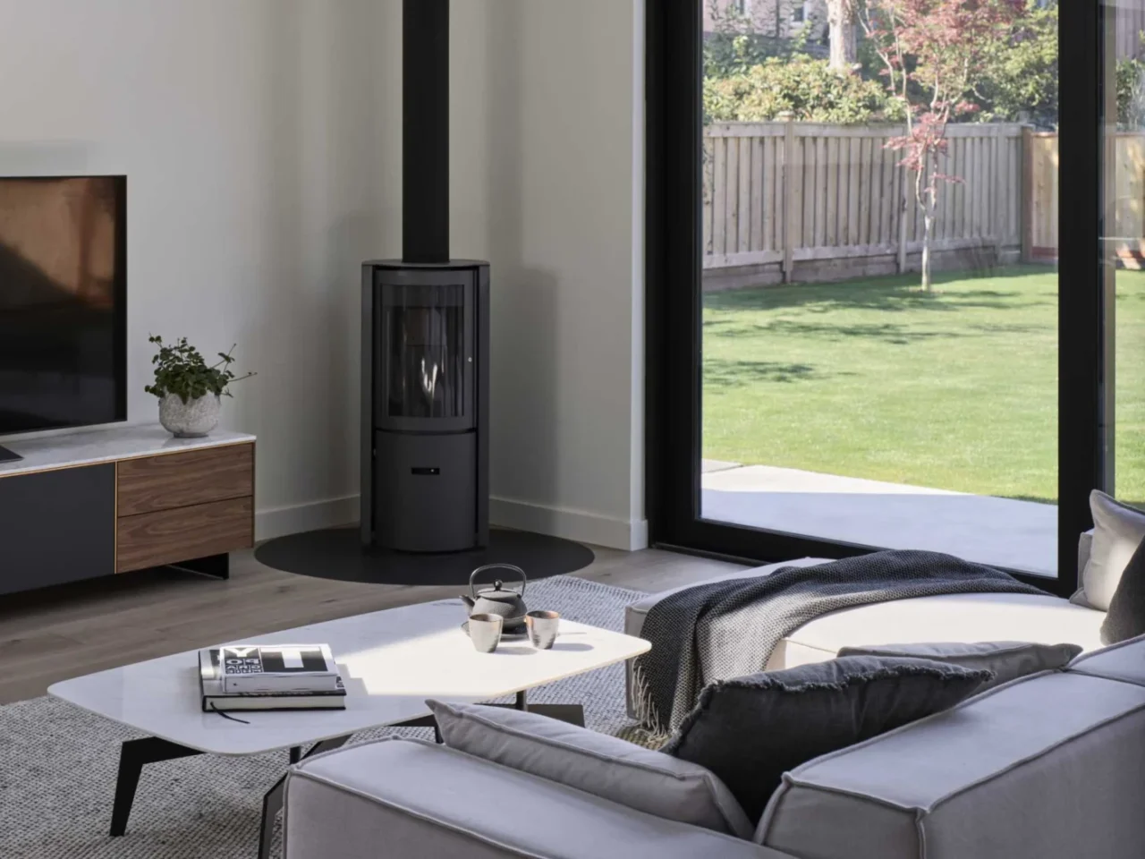 Living room with a black corner fireplace