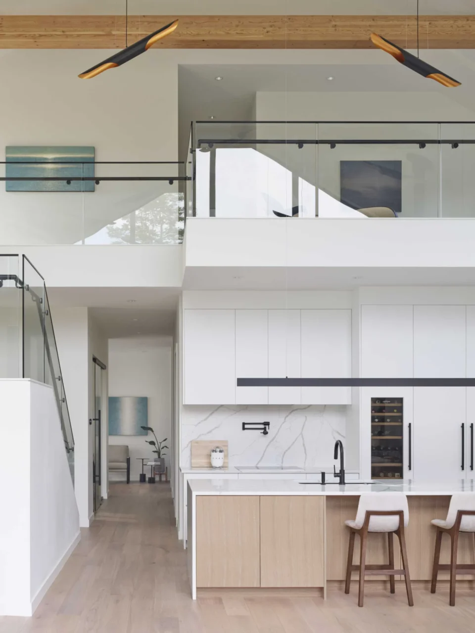 Kitchen beneath the high vaulted ceiling of the barn house