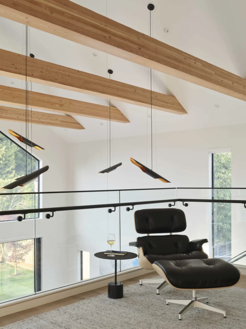 Mezzanine with a glass railing overlooking the living areas