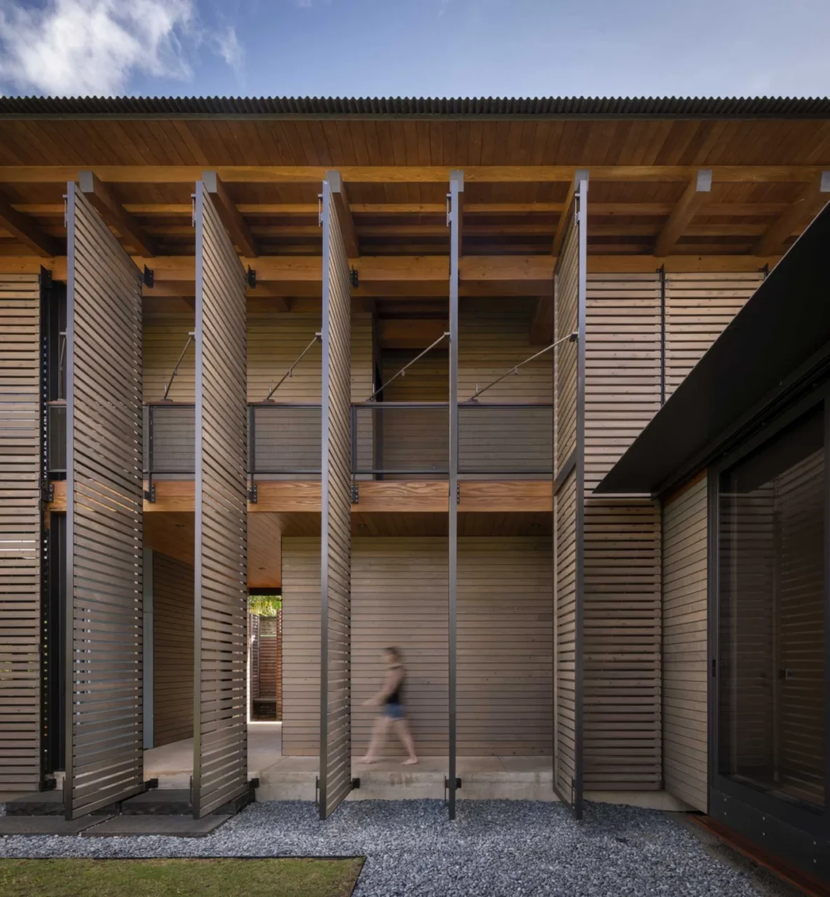 House in Hanalei, Hawaii, by Olson Kundig with operable shutter screens wrapping the facade