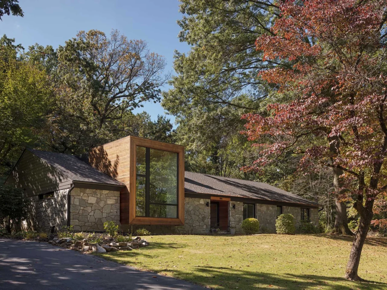 New black aluminium-clad windows and trim on the stone and cedar facade