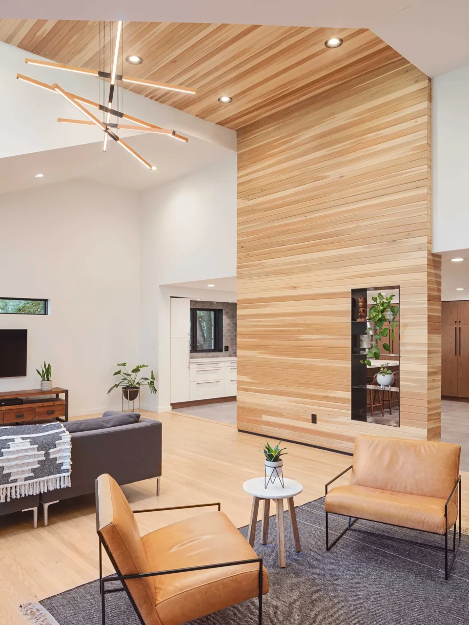 Cedar-clad living room wall with steel-lined pass-through shelving