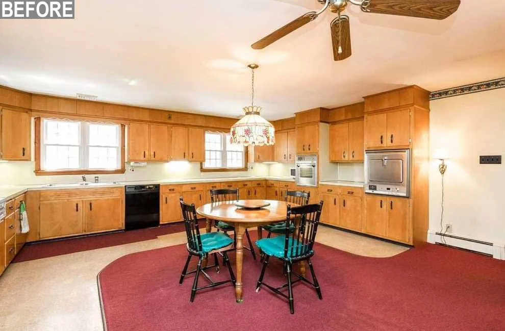 Before: the original kitchen with dated wood cabinets and a round dining table