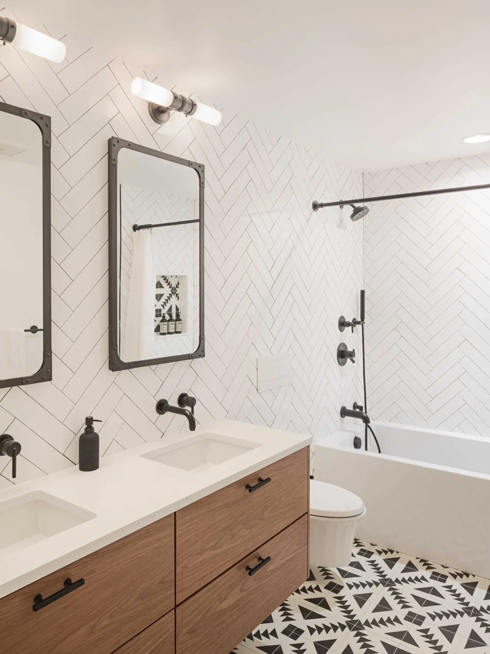 Guest bathroom with a walnut floating vanity, herringbone wall tiles and encaustic concrete floor tiles