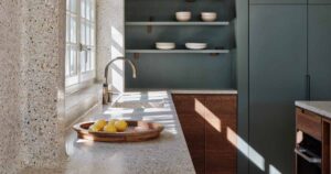 a-seamless-terrazzo-flows-from-the-wall-to-the-countertop-in-this-kitchen