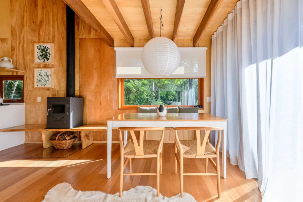 Dining table with a bench running under the window to the fireplace