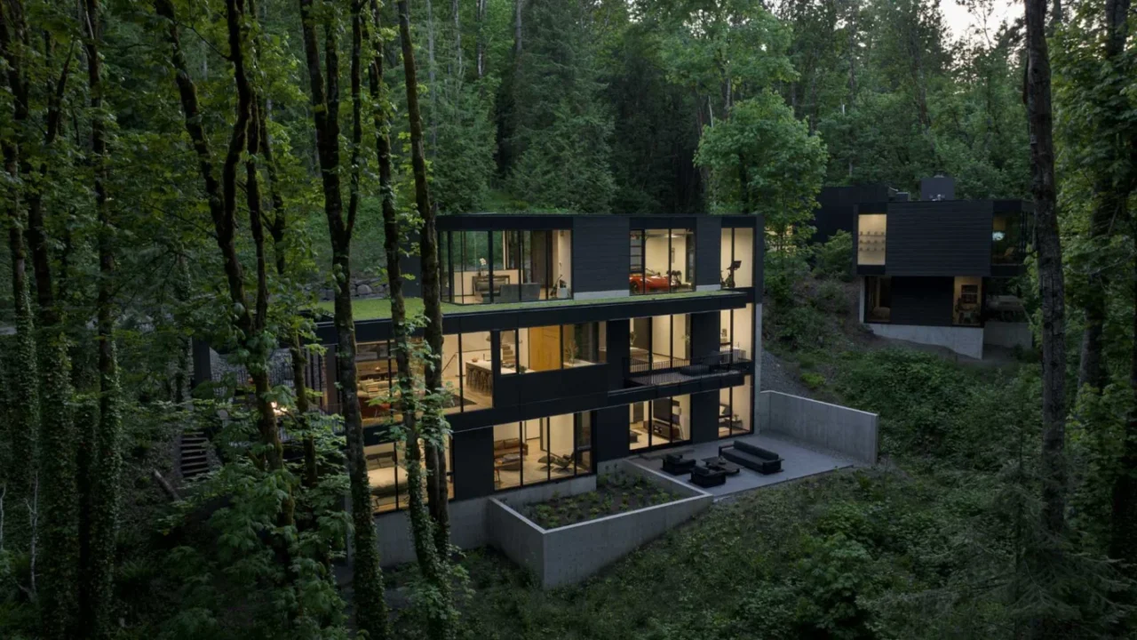 Dark multi-level house on a steep wooded slope in Forest Park, Portland