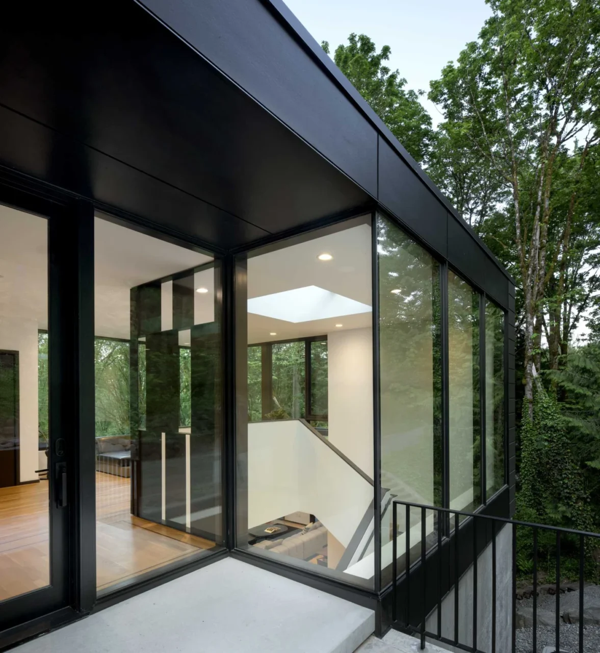 Glass front door and entry of the bronze-black clad home