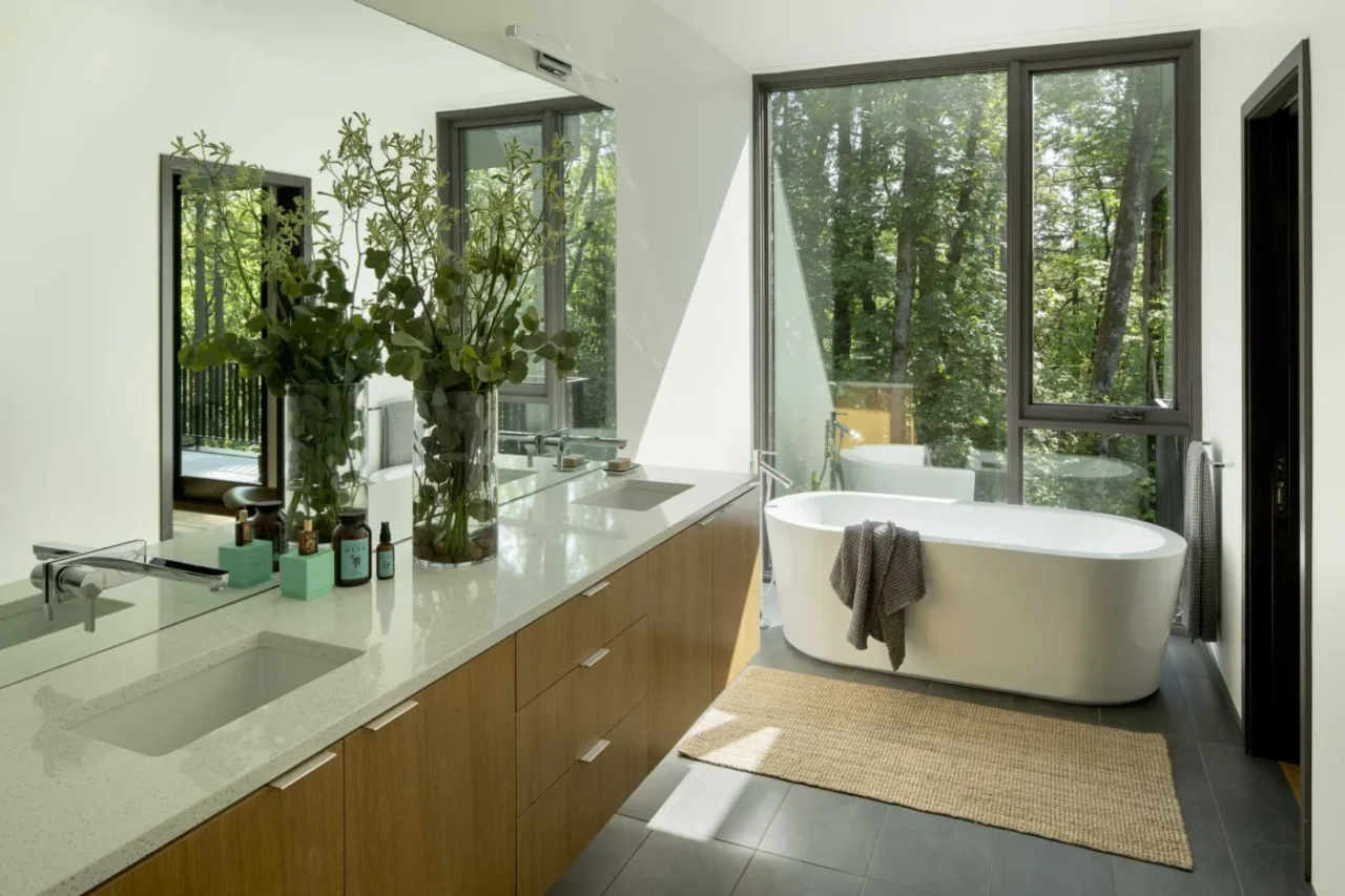 Ensuite bathroom with a freestanding bathtub in front of a full-height window