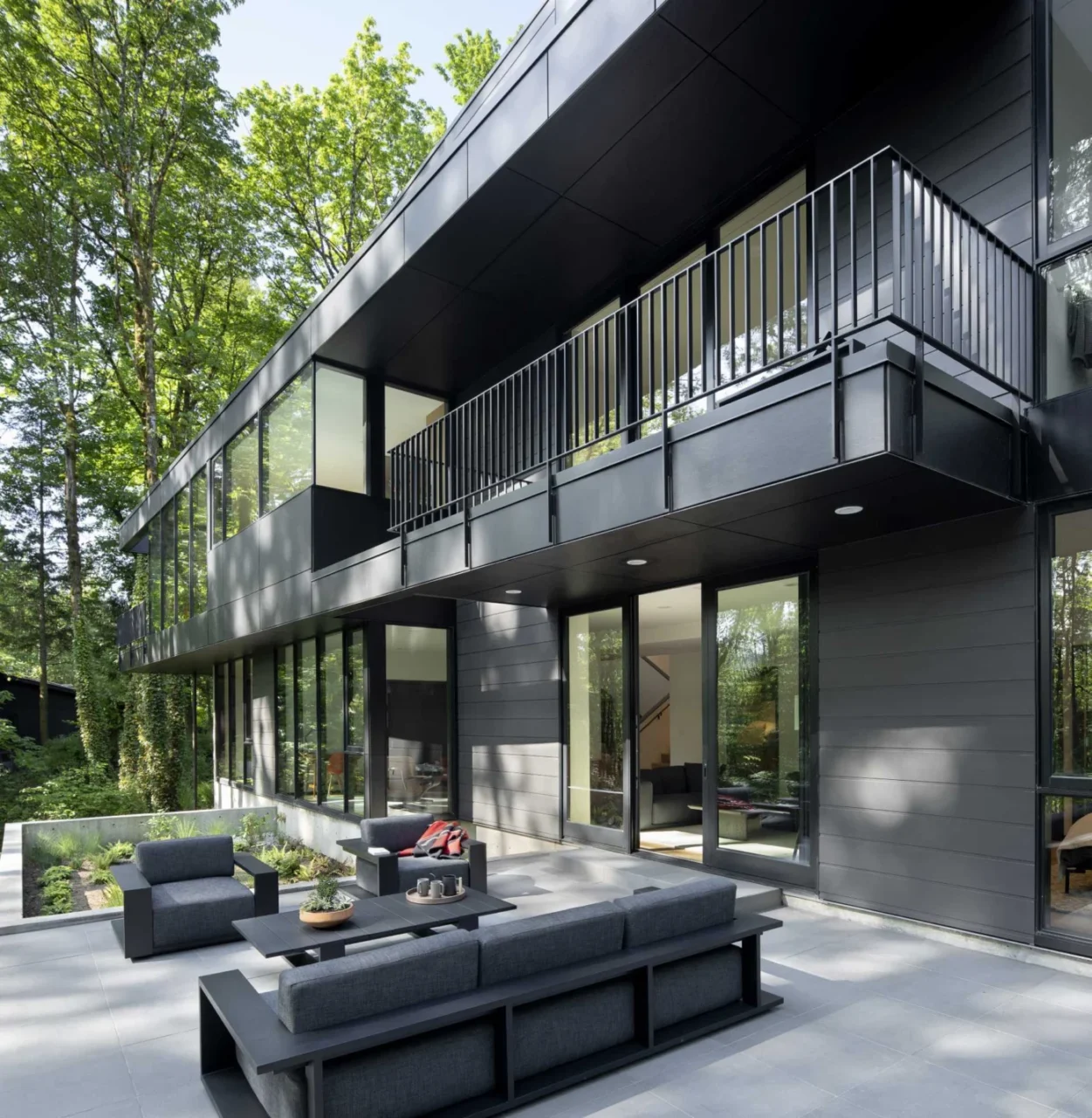 Lower-level rooms opening to a furnished patio and the forest
