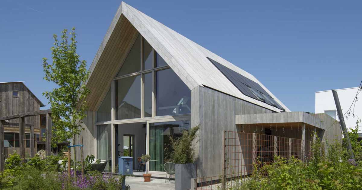 this-barn-inspired-home-hides-a-playroom-with-climbing-wall-under-its-gable-roof