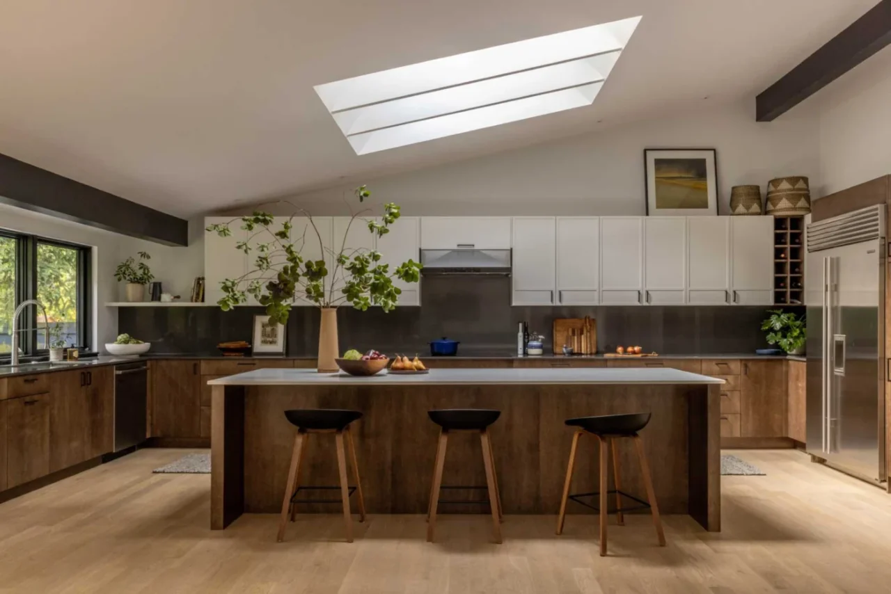 Kitchen with wood and white cabinets and windows down to the counter