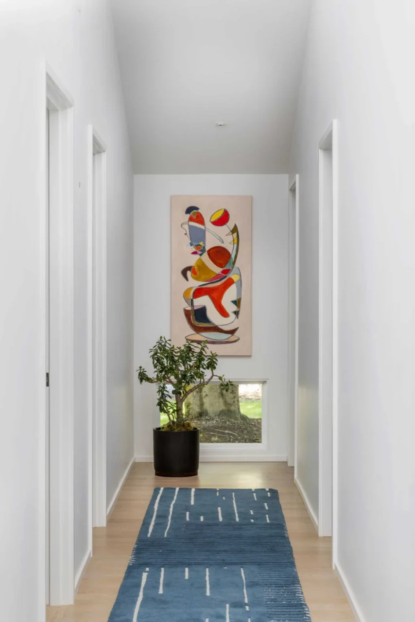 Hallway with a low window and a single artwork at the end