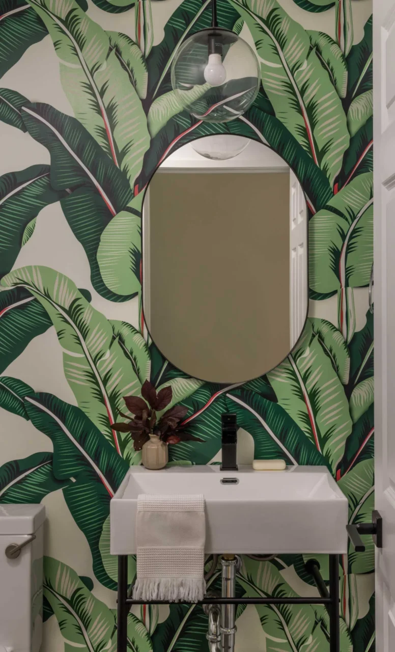 Powder room with tropical print wallpaper