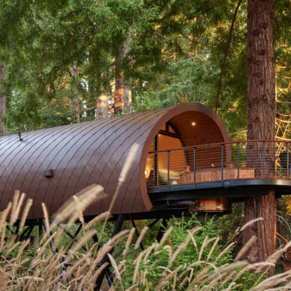 a-tube-shaped-treehouse-wrapped-in-diamond-shaped-metal-tiles