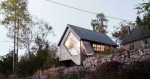 a-unique-window-shape-helps-frame-the-view-from-inside-this-cabin