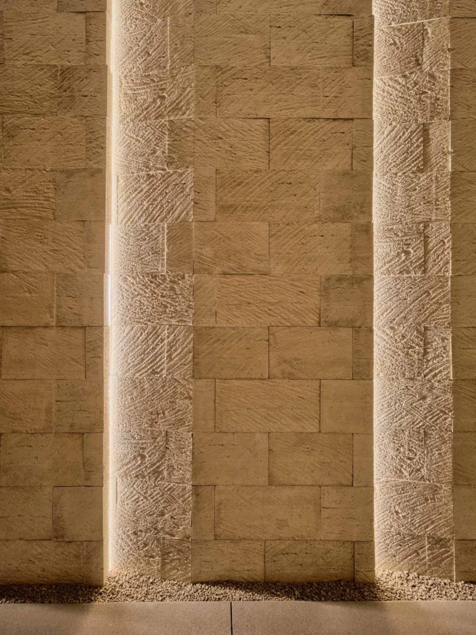 Entry lit between stone walls