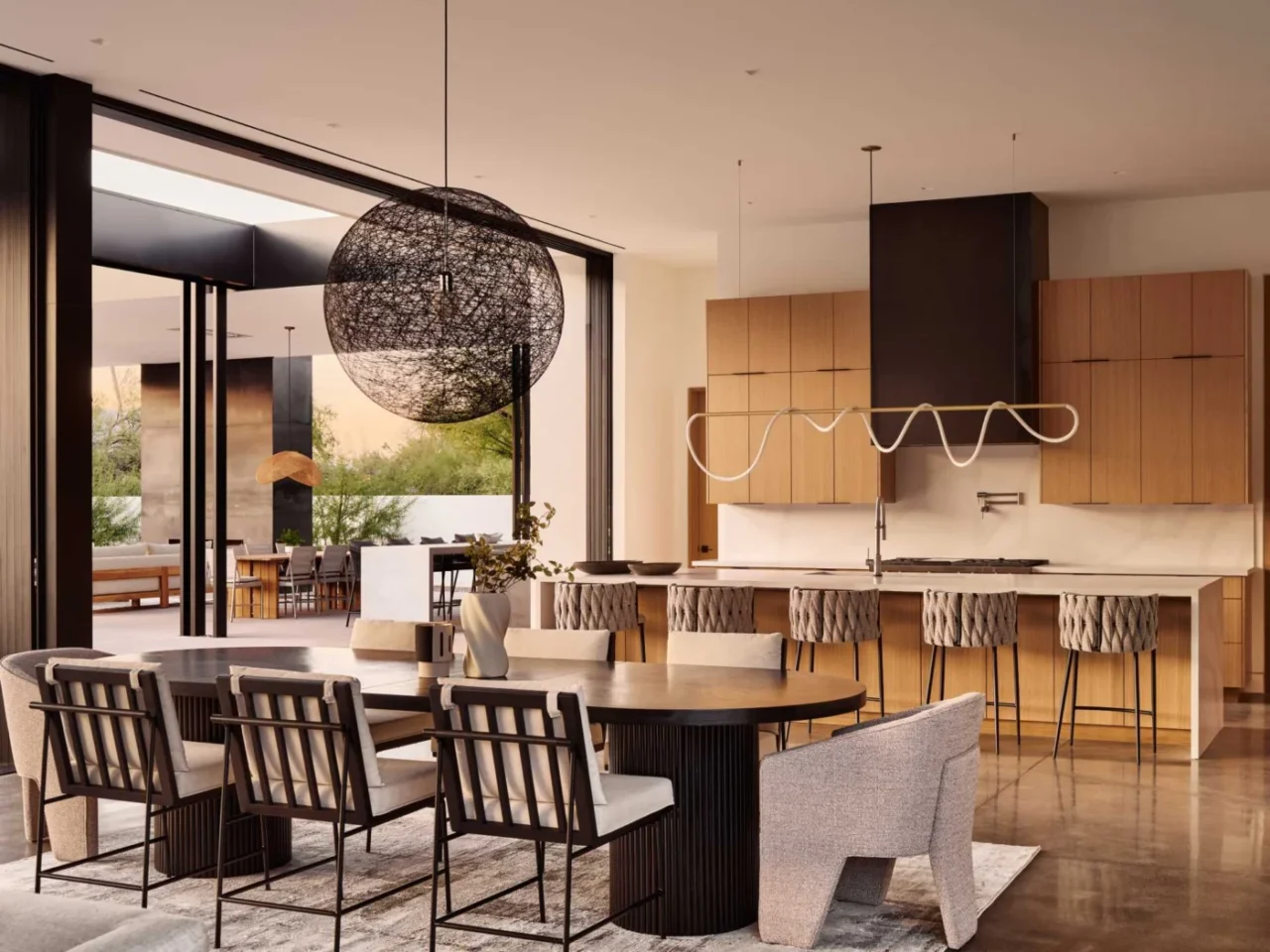 Open dining area between the living room and kitchen on concrete floors