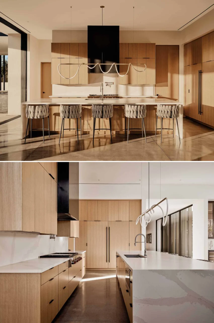 Kitchen with a sculptural pendant over the island and tall wood cabinets