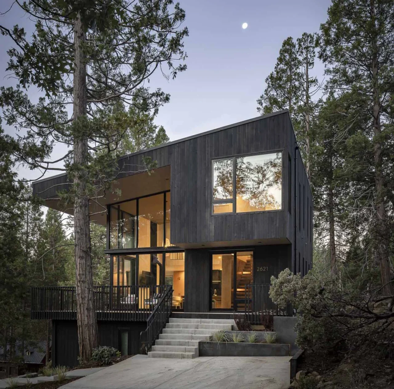 Cabin in Wawona, California, clad in dark vertical wood siding among trees
