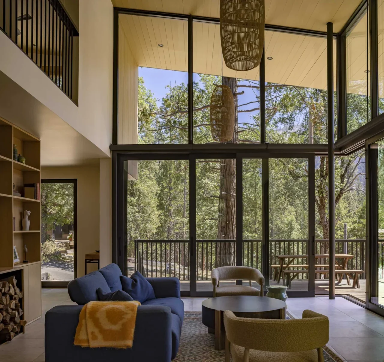 Double-height living room with walls of windows bringing in daylight