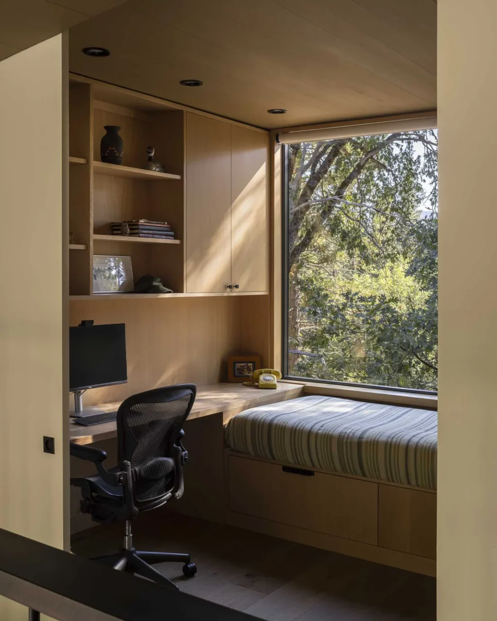 Upstairs room with a built-in desk, shelving and cabinetry