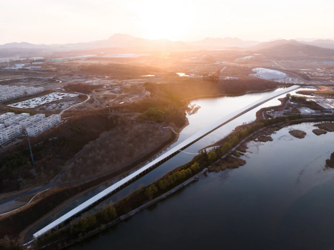 Aerial view of the Zaishui Art Museum stretching across the lake in Rizhao