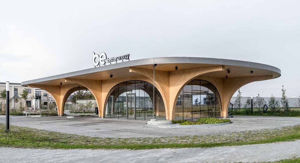 large-wood-arches-dramatically-elevate-the-roof-of-this-charging-station