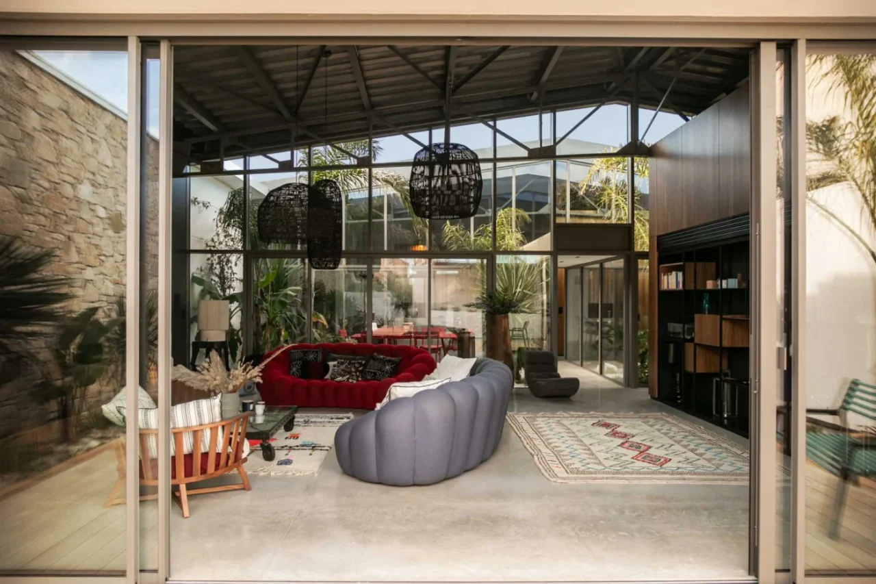 Living room in the warehouse conversion with a built-in library, red couch and wall-length storage unit