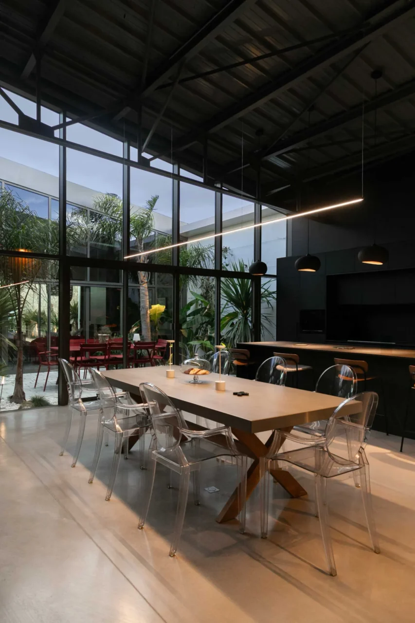 Open-plan dining area under high black ceilings in the warehouse conversion