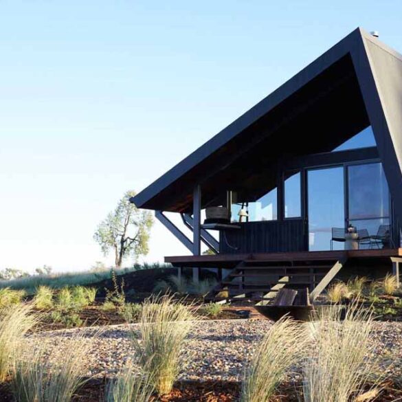 a-metal-roof-wraps-around-this-off-grid-cabin-to-protect-it-from-the-elements