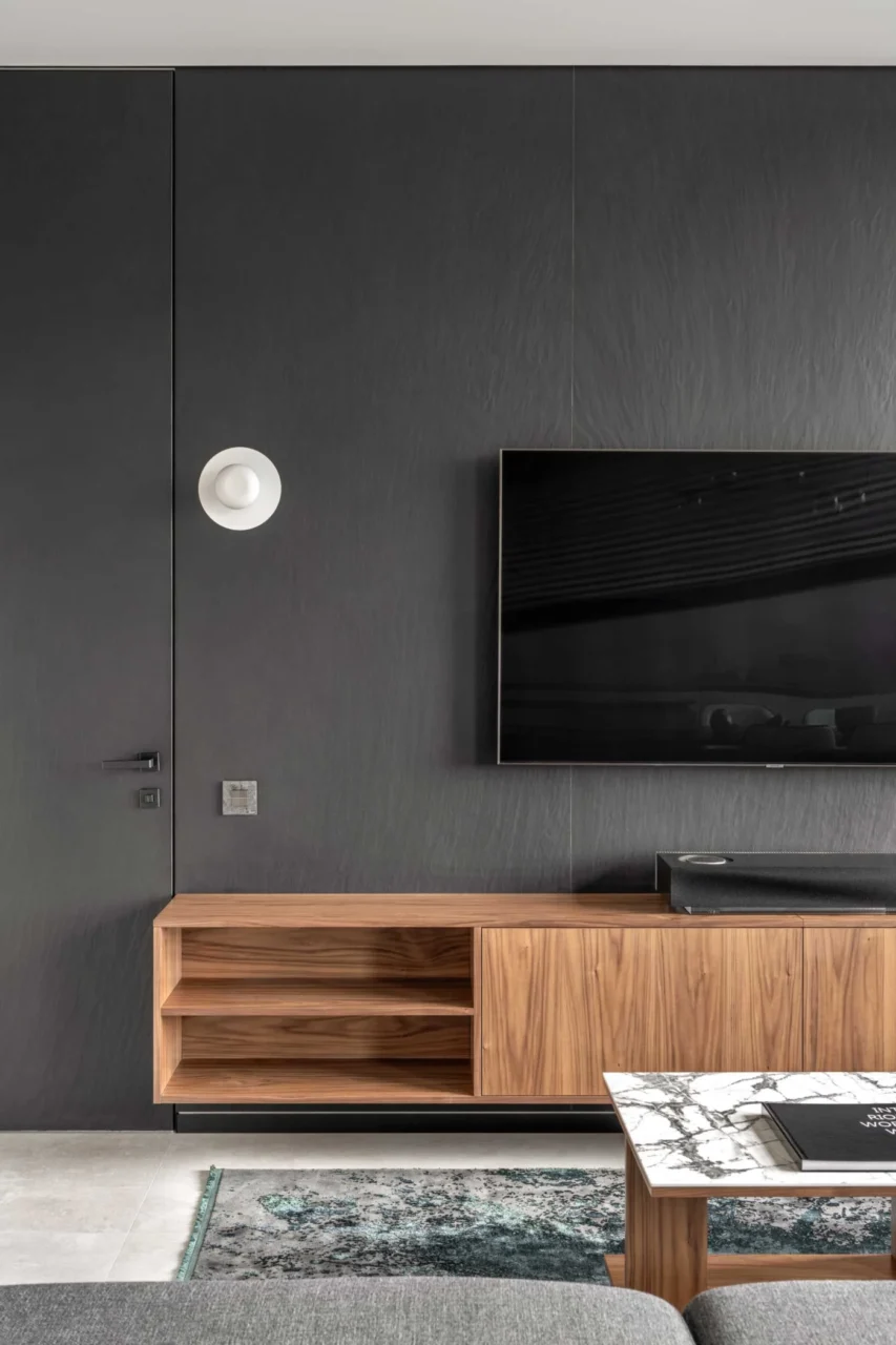 Living area lit by large windows, technical lights and spotlights