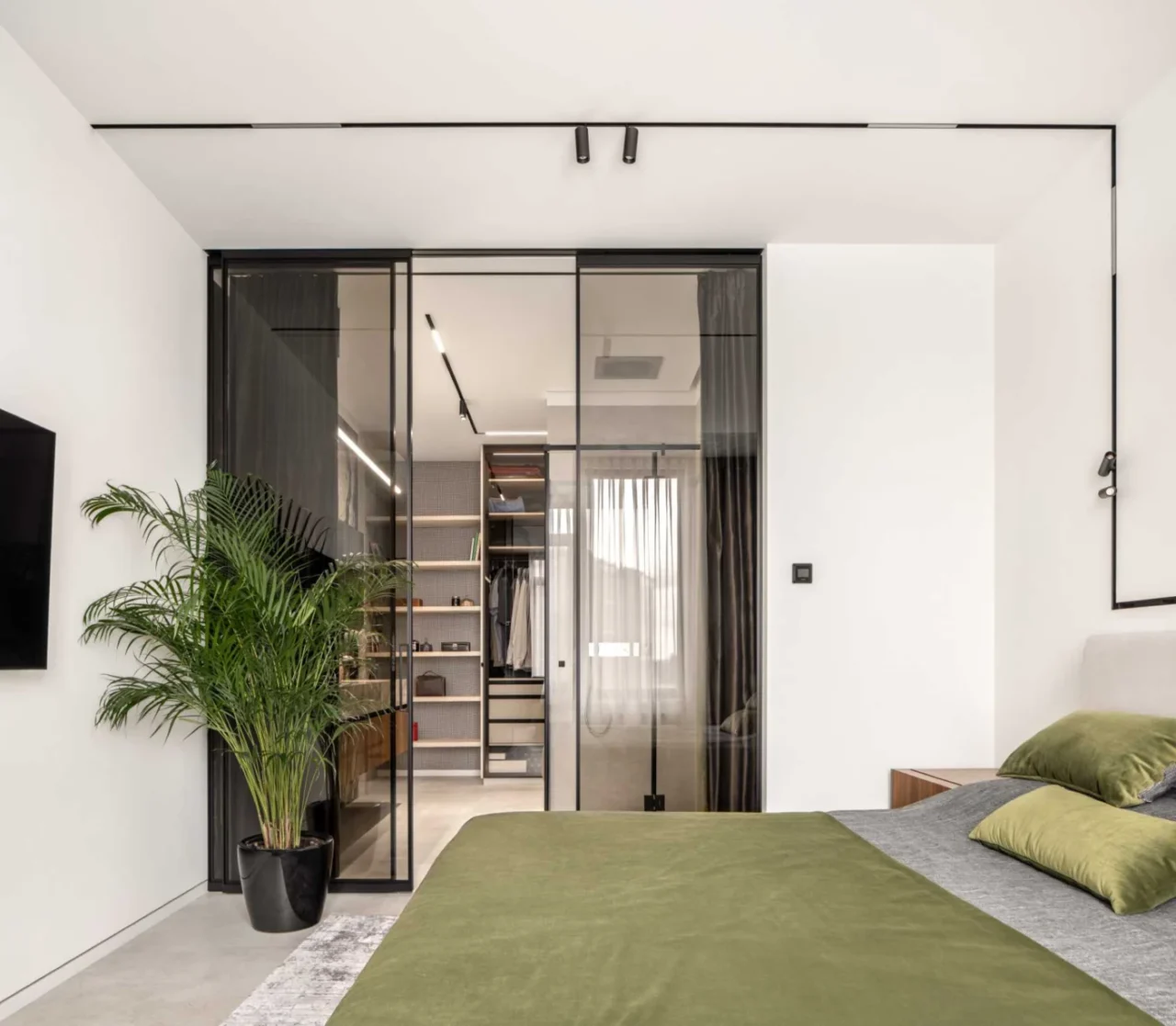 Black-framed sliding glass doors from the bedroom to the ensuite and dressing room