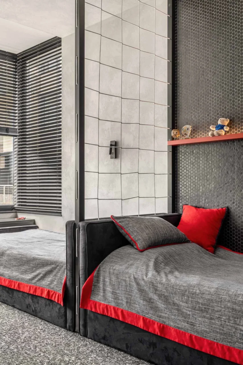 Black and red furniture in the shared kids’ bedroom