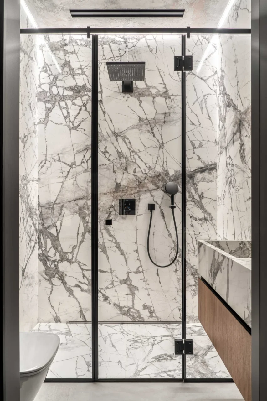 Bathroom with stone tiles on the walls and floor and a floating vanity