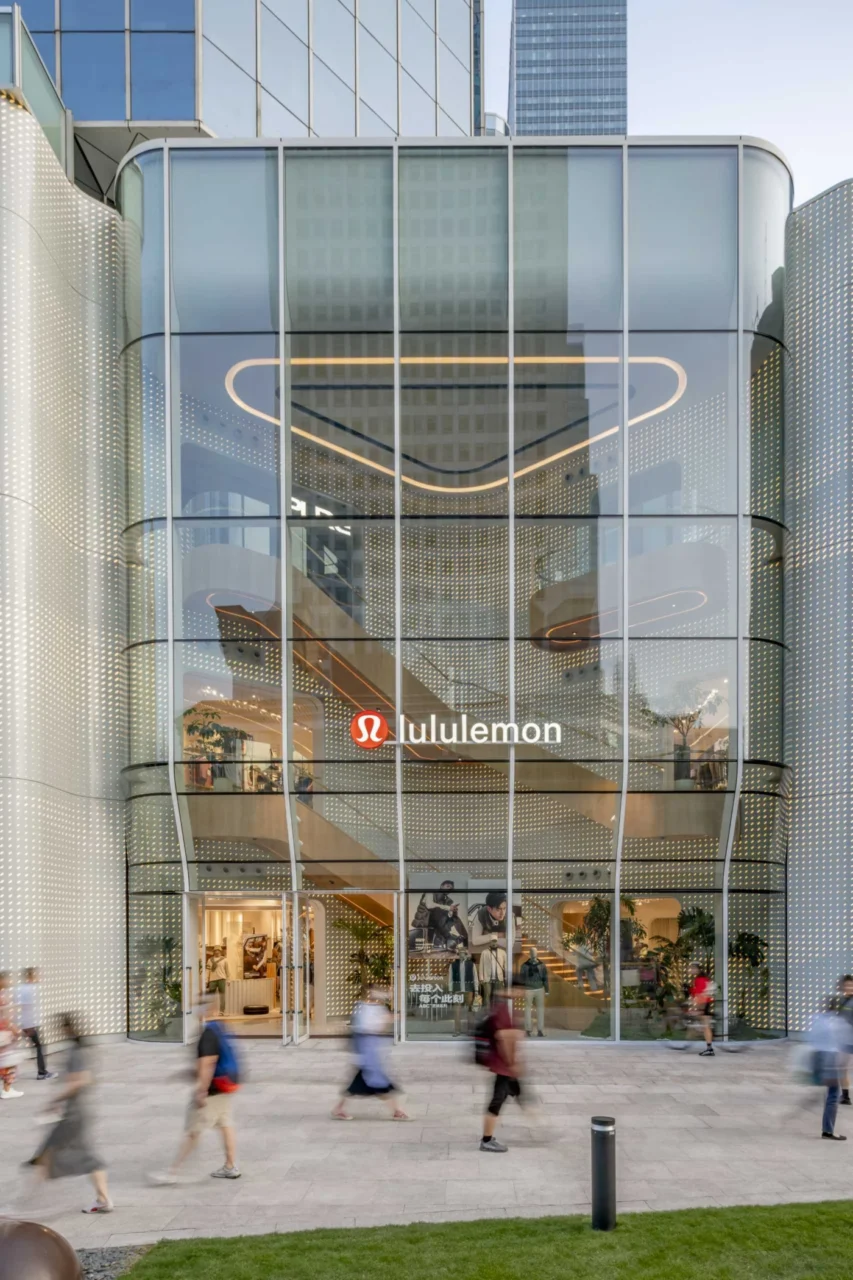 Curved glass window revealing the grand staircase inside the Lululemon flagship