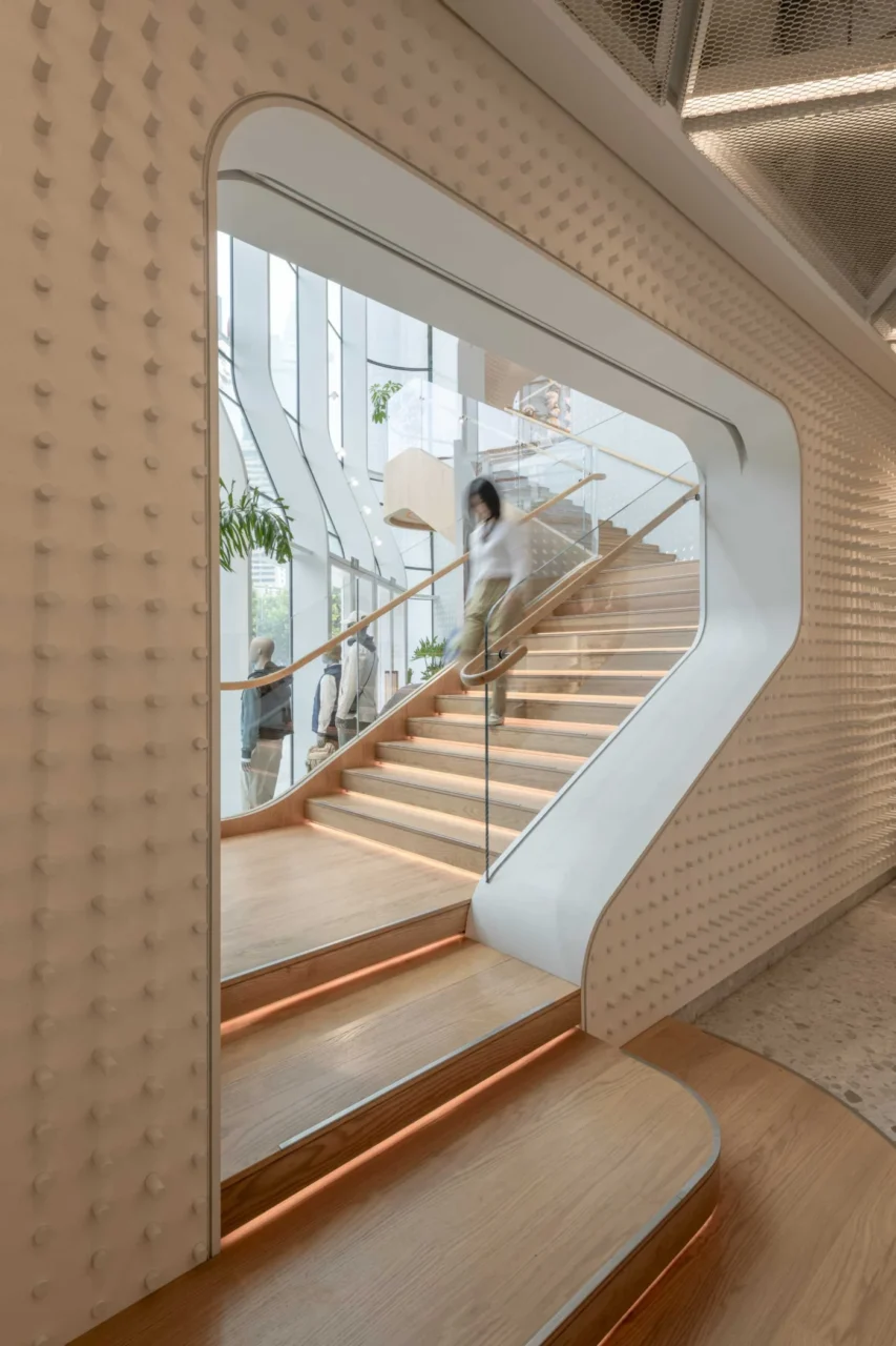 Interior with curved walls and a large staircase connecting the floors
