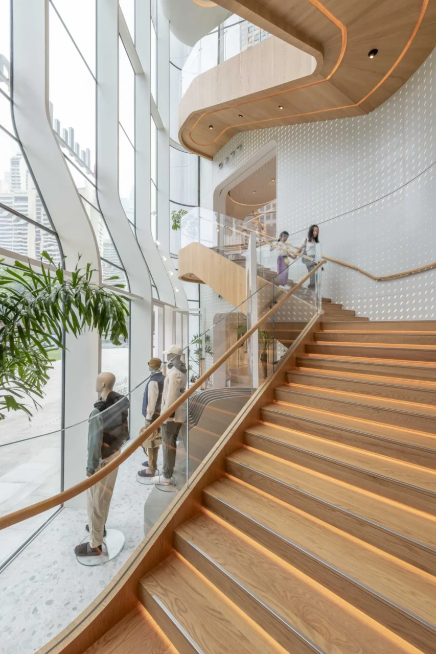 Curved walls and staircase linking the levels of the store