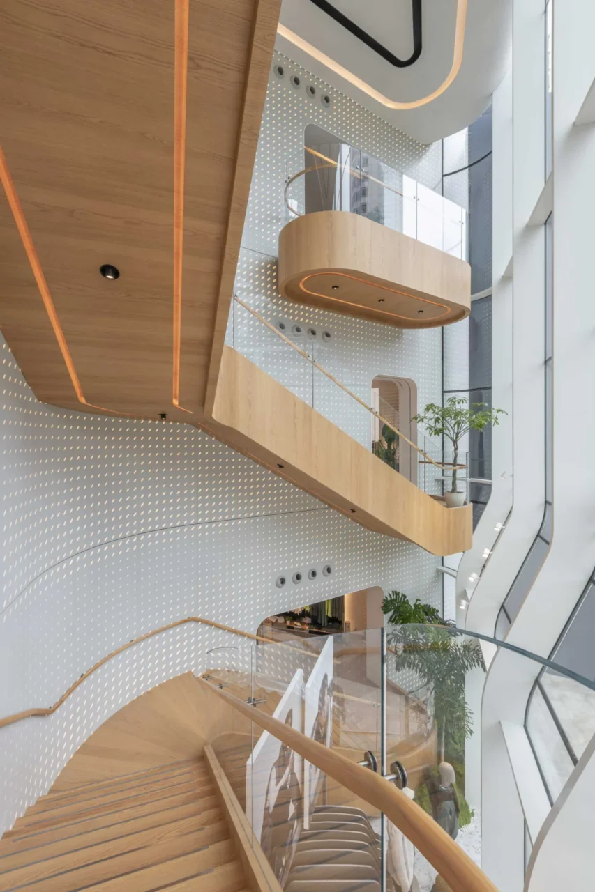 Patterned curved walls around the wood staircase