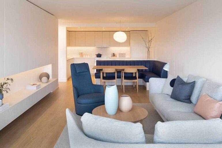 banquette-seating-separates-the-kitchen-from-the-living-room-inside-this-apartment