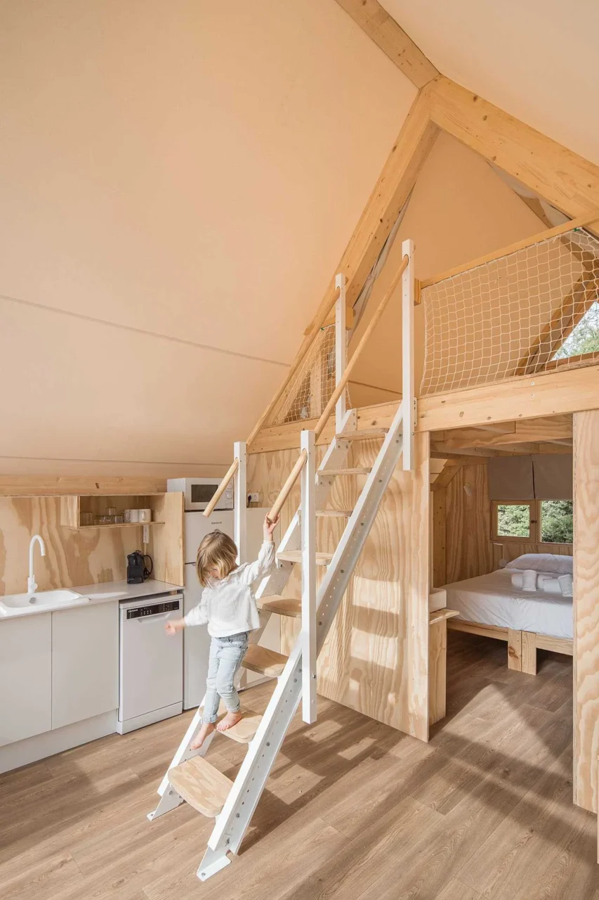Loft bedroom with two single beds under the tent roof