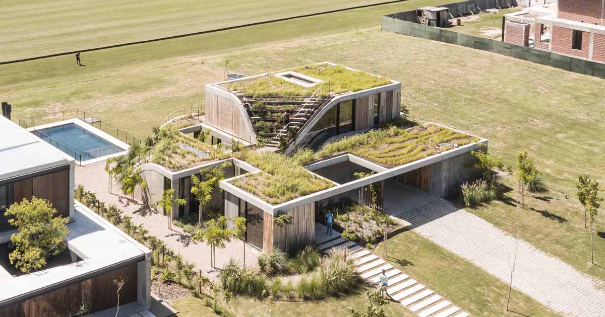 a-house-that-rises-from-the-ground-forming-a-three-level-garden
