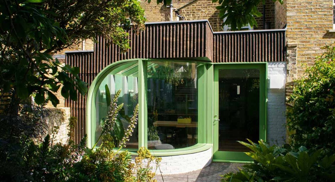 a-house-extension-with-a-curved-window-makes-room-for-a-new-kitchen-at-this-home-in-london